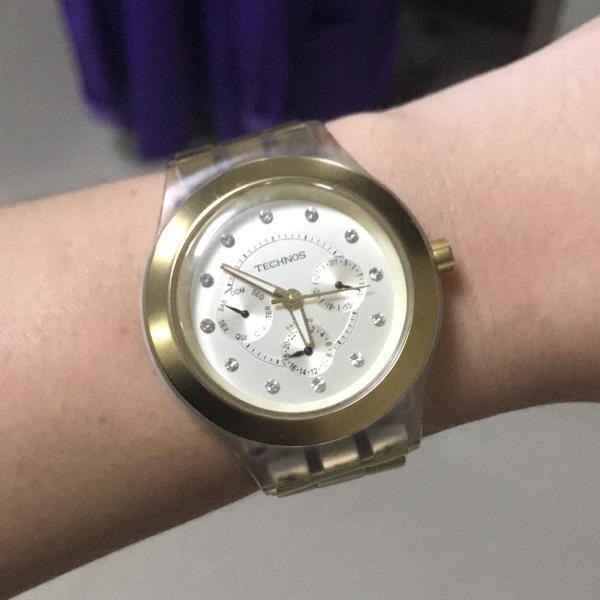 relógio technos dourado com transparente