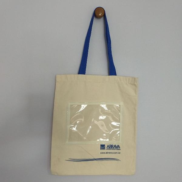 bolsa tipo sacola retornável em lona com alça azul e bolso
